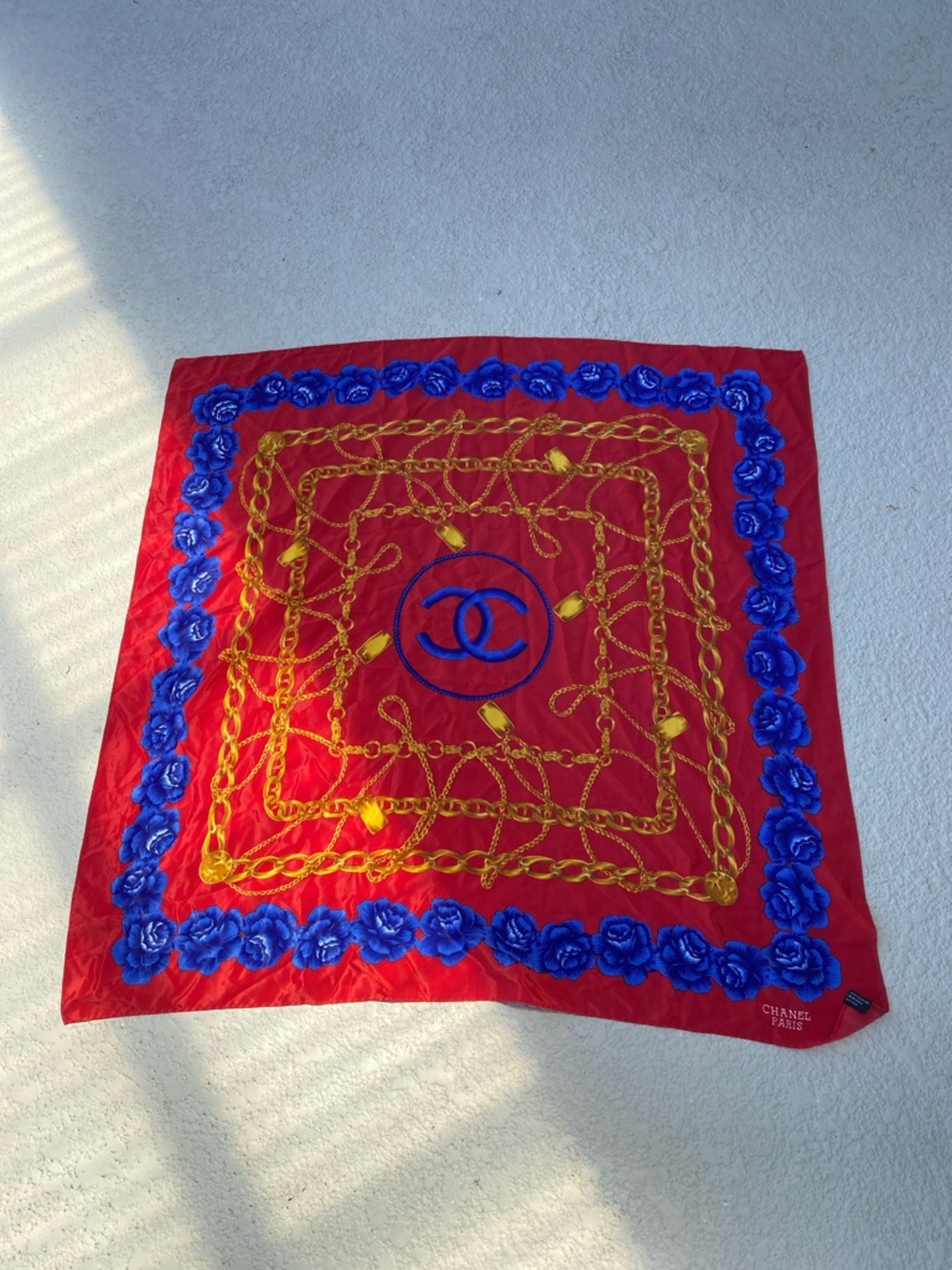 Red Silk Scarf with Bold Blue Floral and Gold Chain Motif